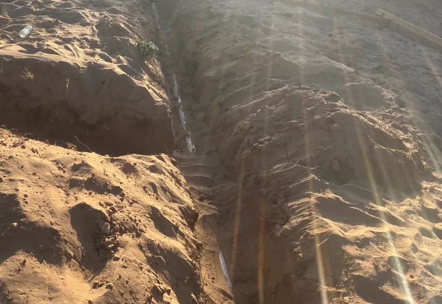 A new pipe laid in a trench of sand